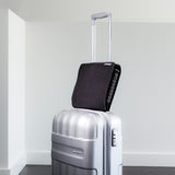 The Airpocket has a wide band on the back that slips over the extended handle of your suitcase